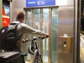 Young guy with a bicycle waiting for the elevator in Darmstadt Main Station, Germany