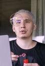 A young guy blows soap bubbles while working with a laptop Royalty Free Stock Photo