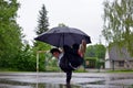 Young guy breakdance dancing in the rain with an umbrella Royalty Free Stock Photo