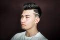 Young guy brunette with pompadour volume haircut 50s - 60s. real photo retro hair style for barbershop Royalty Free Stock Photo