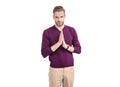 Young guy in casual style keep hands clasped together isolated on white, praying Royalty Free Stock Photo