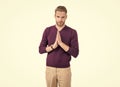 Young guy in casual style keep hands clasped together isolated on white, praying Royalty Free Stock Photo