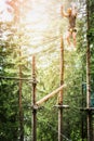 Young guy is climbing on the rope in climbing forest on nature bakgrund Royalty Free Stock Photo