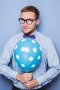 Young guy with a colorful balloon in his hand. Party, birthday, Valentine Royalty Free Stock Photo