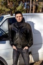 A young guy of criminal appearance in a black leather jacket Royalty Free Stock Photo