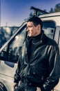 A young guy of criminal appearance in a black leather jacket Royalty Free Stock Photo