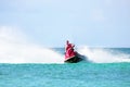 Young guy cruising on a jet ski on the caribbean sea Royalty Free Stock Photo