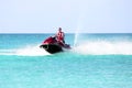 Young guy cruising on a jet ski on the caribbean sea Royalty Free Stock Photo