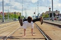 Young guy dancing breakdance on tramlines in the city Royalty Free Stock Photo