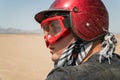 Young guy during desert excursion by quad - Man in helmet and adventure clothes in exotic scenarios - Concept of activity holiday, Royalty Free Stock Photo