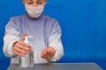 Young guy disinfecting hands with a sanitizer. Handwashing and hand hygiene during the covi pandemic 19