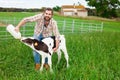 Guy feeds two week old calf from bottle with dummy at lawn Royalty Free Stock Photo