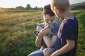 Young guy found and picked up little kitten during walking in field, homeless domestic animals care Royalty Free Stock Photo