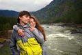 Young guy and girl in the mountains of Altai on the Katun River.