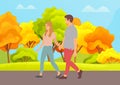 Young guy and girl smiling holding hands walking in autumn day in park. Couple walking outdoor Royalty Free Stock Photo