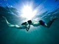 A young guy and a girl swim towards each other underwater Royalty Free Stock Photo