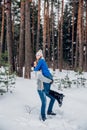 Young guy and girl in winterwear enjoying snowfall and having fun