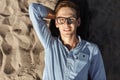 Young guy with glasses, posing, lying on the beach on the sand, work on vacation, suitable for advertising Royalty Free Stock Photo