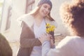 Young guy granting flower to his girlfriend in valentine day Royalty Free Stock Photo