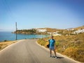 Young guy on the highway. A man at a resort tries to stop the car. A man in a colorful summer shirt overlooking the sea Royalty Free Stock Photo