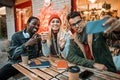 Three friends making selfie in a street cafe Royalty Free Stock Photo