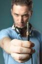 Young guy holding stereo jack plug