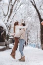 Young guy holds a beautiful girl in his arms. Couple in sweaters. Royalty Free Stock Photo