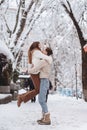 Young guy holds a beautiful girl in his arms. Couple in sweaters. Royalty Free Stock Photo