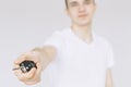 A young guy holds the car keys in his hand. Isolated white background Royalty Free Stock Photo