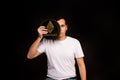 A young guy holds a symbol of the ethereum coin, a modern currency for exchange and purchases