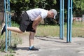 Young guy on the horizontal bar in nature in sunny, summer weather. Copy space - concept of sport, quarantine, social