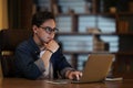 Young guy independent contractor working from home late at night Royalty Free Stock Photo