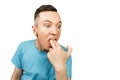 Young guy inserts two fingers in the mouth to induce vomiting, on a isolated white background Royalty Free Stock Photo