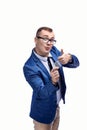 Young guy in a jacket, bow tie, glasses holds a condom in his hand. Isolated on white background Royalty Free Stock Photo
