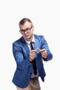 Young guy in a jacket, bow tie, glasses holds a condom in his hand. Isolated on white background Royalty Free Stock Photo