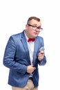 Young guy in a jacket, bow tie, glasses holds a condom in his hand. Isolated on white background Royalty Free Stock Photo