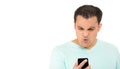 Young guy looking angry at his cell phone Royalty Free Stock Photo