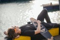 Young guy lying on skateboard spending time at skatepark Royalty Free Stock Photo