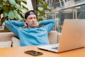 Young guy male businessman thinking about online project, looking laptop work cafe, thinking solution, sitting desk with Royalty Free Stock Photo