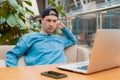 Young guy male businessman thinking about online project, looking laptop work cafe, thinking solution, sitting desk with Royalty Free Stock Photo