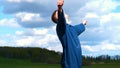 A young guy man, a farmer in a working uniform, walks across a field in rubber boots. Concept of: Freedom, Rubber boots, Lifesty Royalty Free Stock Photo