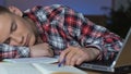 Young guy napping at school desk, educational boredom, examination tiredness