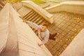 A young guy overcomes obstacles, climbing on concrete walls