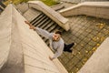 A young guy overcomes obstacles, climbing on concrete walls