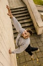 A young guy overcomes obstacles, climbing on concrete walls