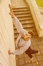 A young guy overcomes obstacles, climbing on concrete walls