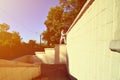 A young guy overcomes obstacles, climbing on concrete walls