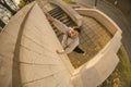 A young guy overcomes obstacles, climbing on concrete walls