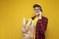 young guy with a package of groceries speaks on the phone, the buyer orders food by phone Royalty Free Stock Photo