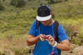 Young guy peels ripe tasty cactus fruit, known as prickly pear or fruit of Opuntia ficus-indica, growing naturally in the dry, Royalty Free Stock Photo